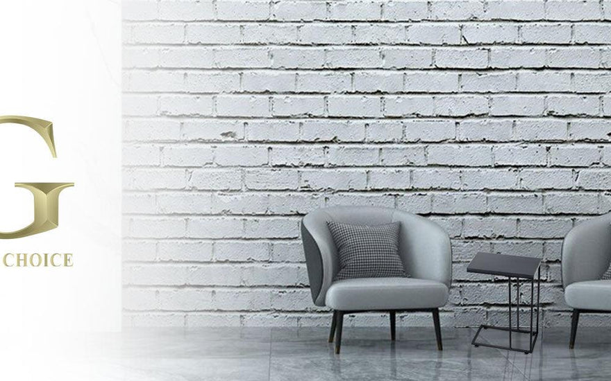 Modern living room with two gray armchairs, a small black side table, and a plant against a white brick wall